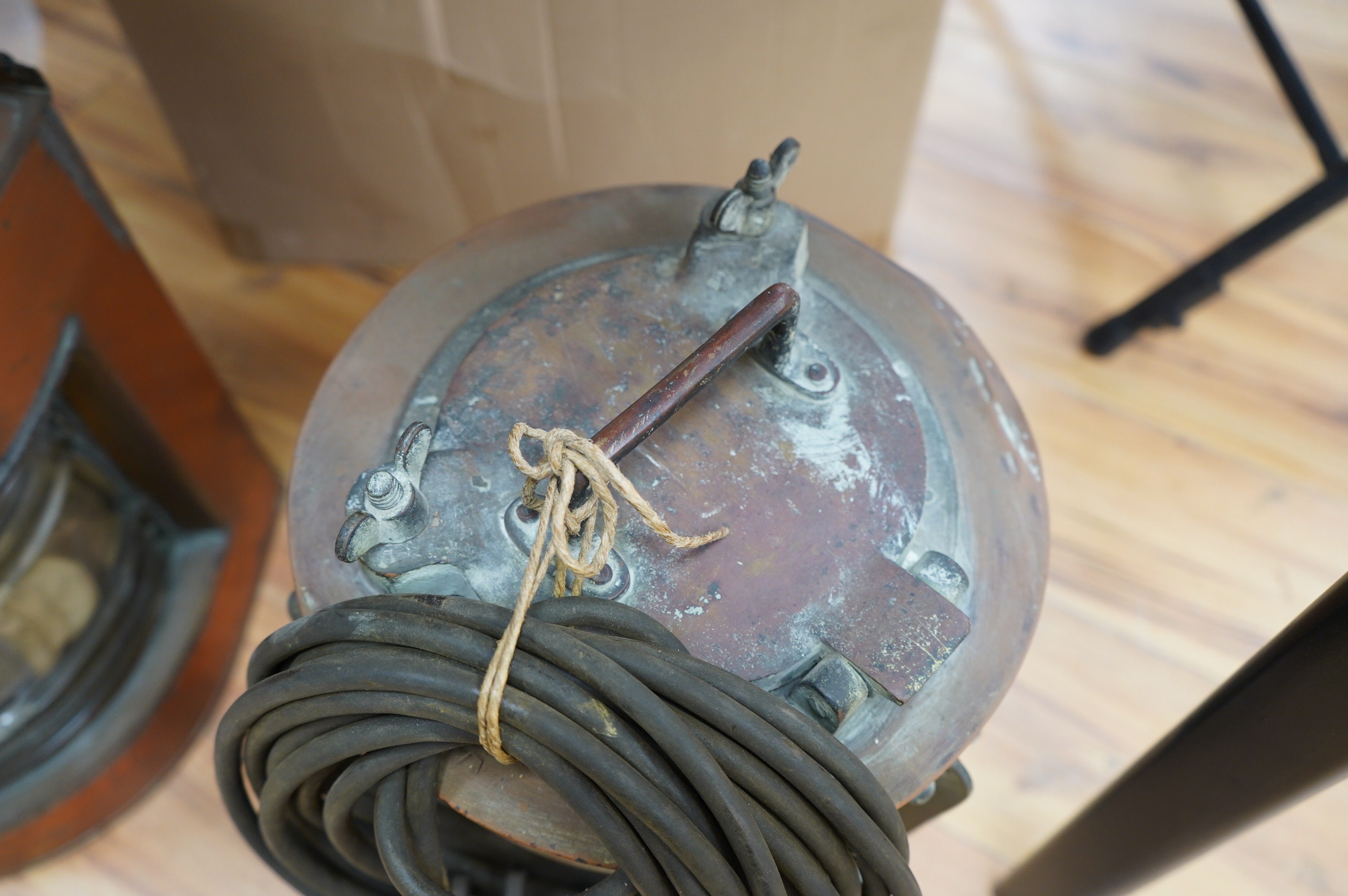 An early 20th century ship’s copper mast head lamp, and another copper ship’s lamp, largest 69cm high. Condition - fair